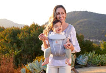 A mon outside with a baby in the Ergobaby Omni Breeze baby carrier