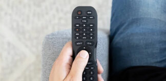 A Philips universal remote in hand.