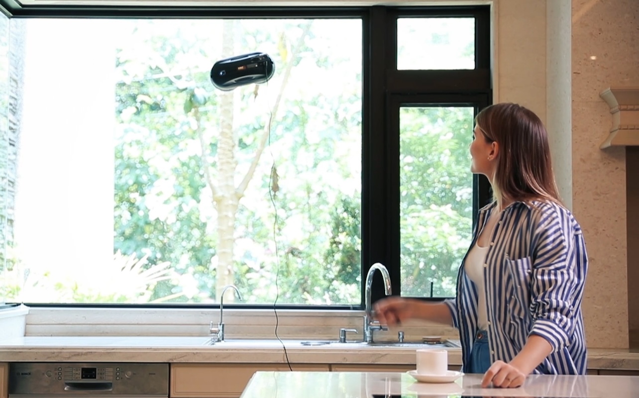 Robotic window cleaner cleaning kitchen window.