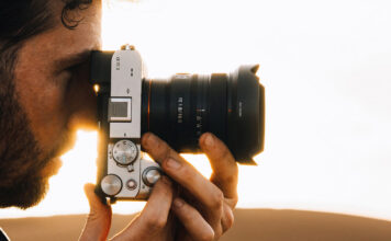 Man taking photo on Sony camera with wide-angle lens.