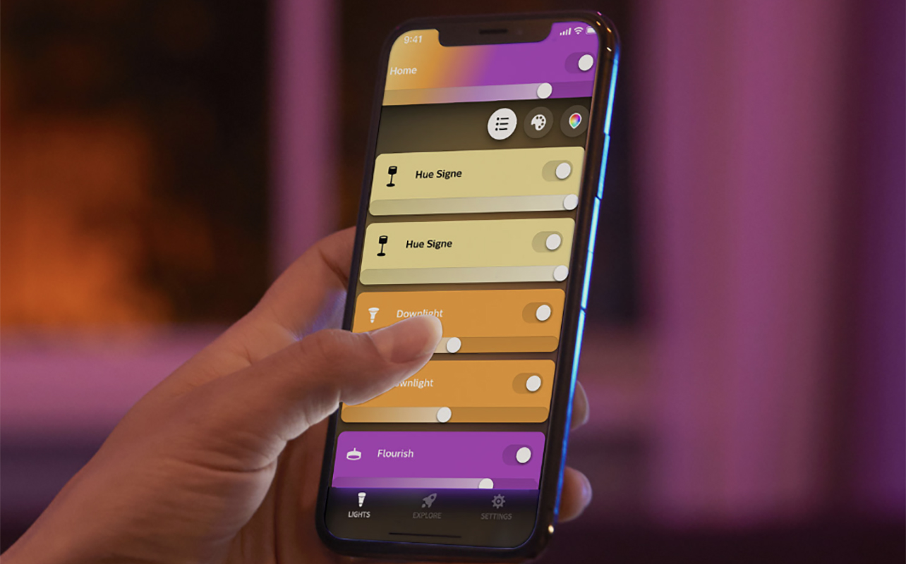 The Philips Hue smart light app on a phone being held by a hand.