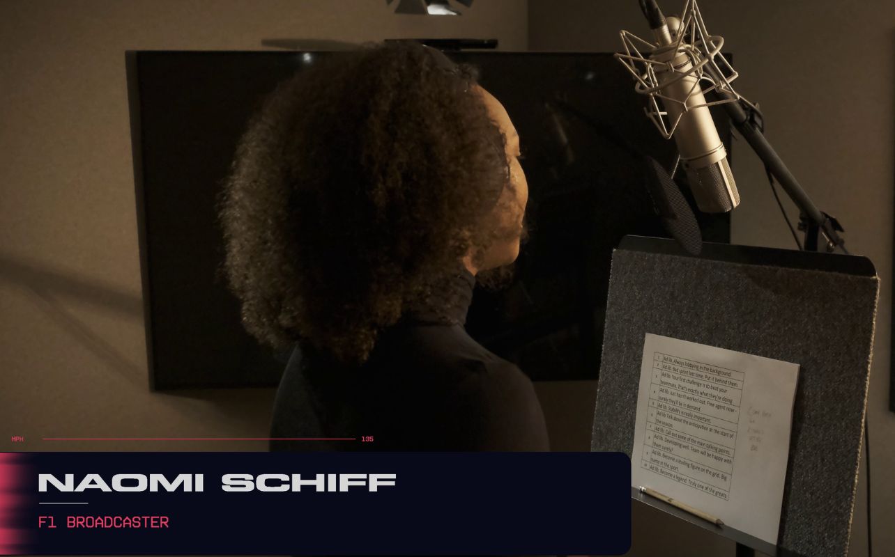 A voice actor in a professional recording studio, capturing dynamic dialogue for EA SPORTS F1 25. Equipped with a high-quality condenser microphone. The soundproofed booth ensures clear audio capture, while a script holder and script are present.